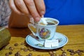 Old woman sweetening the turkish coffee