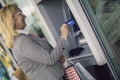 Old woman using ATM machine with credit card Royalty Free Stock Photo