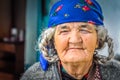 Old woman with violet headcloth in Tajikistan Royalty Free Stock Photo