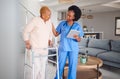 Old woman, walker and nurse with tablet, disability and health and help, physical therapy and medical results. Arthritis Royalty Free Stock Photo