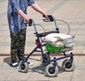 Old woman walks with a wheeled walker