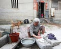 Old woman washing clothes