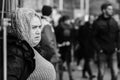 Old woman watching Earth-strike demonstration from a sidewalk