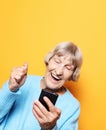 Old woman wearing blue sweater  talking on cell phone Royalty Free Stock Photo