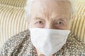 Old woman wearing medical mask for protection of covid19 virus