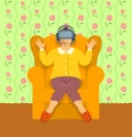 Old woman wearing virtual reality glasses at home