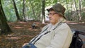 Old woman in a wheelchair in a city park Royalty Free Stock Photo