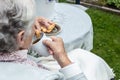 Old woman in a wheelchair drinking tea on the terrace Royalty Free Stock Photo