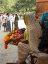 Varanasi, Uttar Pradesh, India - November 2, 2009 An old woman in white saree selling fresh flowers