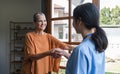 The old woman who owned the house smiled with joy and went out to welcome the young nurse who had come to check on her