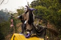 Old woman witch figurine in garden outdoor on forest mountain at pai city hill valley