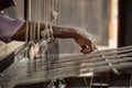 Old woman working with her hands on a rustical loom Royalty Free Stock Photo