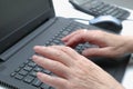 Old Woman working at home office hand on keyboard close up. Close up of woman hands typing on laptop Royalty Free Stock Photo