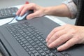 Old Woman working at home office hand on keyboard close up. Close up of woman hands typing on laptop Royalty Free Stock Photo