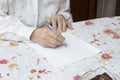 The old woman writes handwritten will. Royalty Free Stock Photo