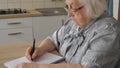 Old woman is writing letter or the last will Royalty Free Stock Photo