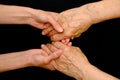 Old woman and young woman holding hands together Royalty Free Stock Photo