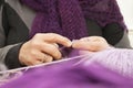 Old womans hands knitting a scarf