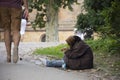 Old women beggar sitting lonely at pathway for begging money fro