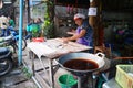 Old women cooking deep-fried doughstick