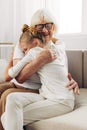 Woman granddaughter love grandmother home hugging child girl happy sofa couch family Royalty Free Stock Photo