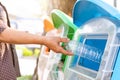 Old women hand throwing away the garbage to the bin/trash, sorting waste/garbage before drop to the bin Royalty Free Stock Photo