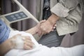 An old women Sick patient lying on bed holding her husband hand in hospital for medical background.Healthcare and Medical for