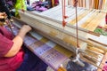 Old women are using the machine - Household Loom weaving - for homemade silk or textile production