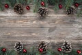 Old wood background with fir branches adorned with baubles and cones. Space for text. Christmas card. Top view Royalty Free Stock Photo