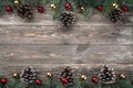 Old wood background with fir branches adorned with baubles and cones. Space for text. Christmas card. Top view. Royalty Free Stock Photo