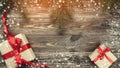 Old wood background with fir branches. Holiday Gifts. Christmas card. Top view. Effect of light and snowflakes Royalty Free Stock Photo