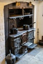 An old wood burning stove in a kitchen with pots and pans on top Royalty Free Stock Photo