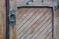 Old wood door antique metal handle weathered background Royalty Free Stock Photo