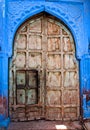 Old wood door with blue wall Royalty Free Stock Photo