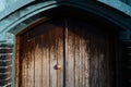 Old wood door with a small handle on red brick wall background Royalty Free Stock Photo