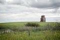 Old wood elevator in the distance sitting in a green meadow Royalty Free Stock Photo
