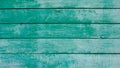 Old wood faded background painted in blue-green color