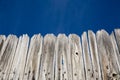 Old wood fence and bright blue sky Royalty Free Stock Photo