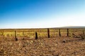 Old wood fence with fire damage on a flat prairie Royalty Free Stock Photo