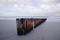 Old Wooden Jetty Ruin on Beach with Ocean in Background Royalty Free Stock Photo