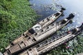 Old wood long tail boat stop at riverbank of Thale Noi lake Royalty Free Stock Photo