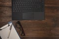 Old wood office desk table with laptop and notepad. Top view with copy space Royalty Free Stock Photo