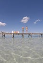 Old wood pier in Alcudia beach in the Spanish island of Mallorca vertical