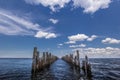 Old wood pier left only poles next to the sea Royalty Free Stock Photo