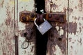 Old wood rural door with old rusty padlock