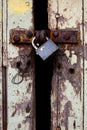 Old wood rural door with old rusty padlock