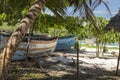 Old wood rusty boats stranded on a tropical beach