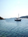 Old wood sailboat in Mediterranean Sea Faros harbor on Greek Isl