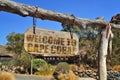 old wood signboard with text welcome to Cape Coral. hanging on a branch