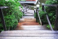 Old wood stairway down outdoor background with jasmine garden flower tree in the side